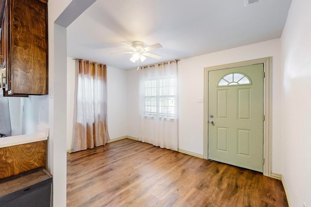 foyer entrance with hardwood / wood-style floors and ceiling fan