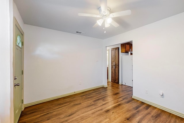 unfurnished room featuring ceiling fan and dark wood-type flooring