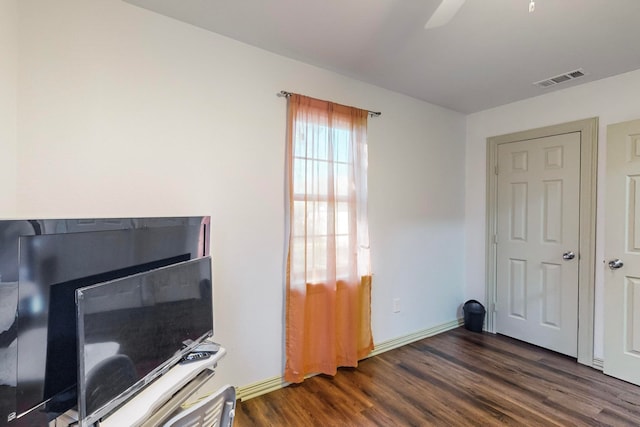 office space with dark hardwood / wood-style floors and ceiling fan