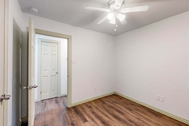 spare room featuring ceiling fan and dark hardwood / wood-style flooring