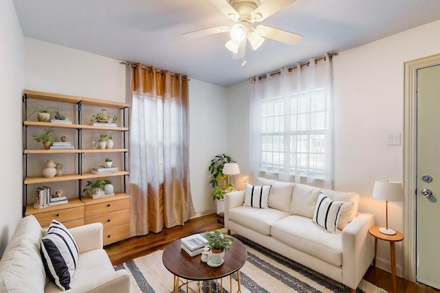 living room with ceiling fan and dark hardwood / wood-style flooring