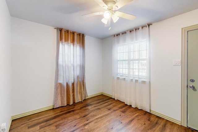 spare room with hardwood / wood-style floors and ceiling fan