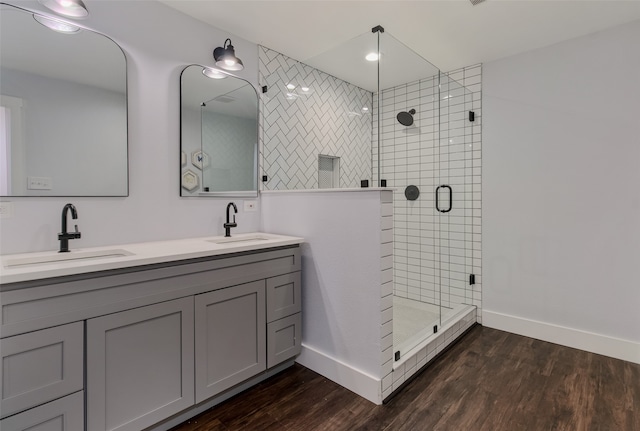 bathroom with hardwood / wood-style floors, vanity, and walk in shower