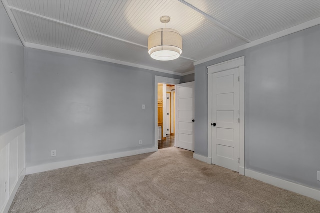 carpeted spare room with ornamental molding