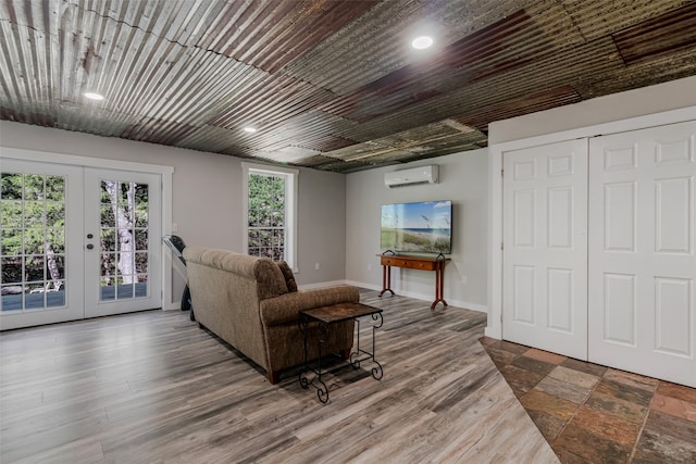 living room with wood-type flooring, french doors, and a wall mounted AC