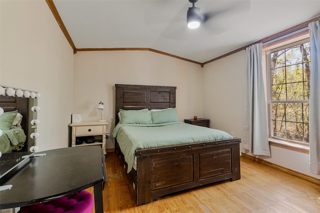 bedroom featuring light wood-type flooring, crown molding, ceiling fan, and lofted ceiling