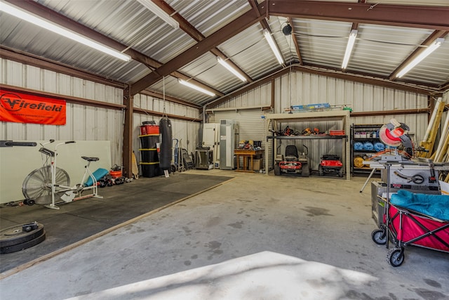 garage with a workshop area and stainless steel refrigerator