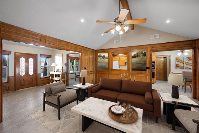 living room with light wood-type flooring, high vaulted ceiling, and ceiling fan