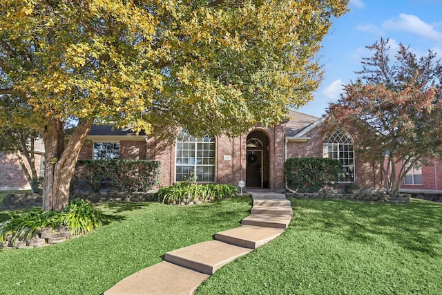 view of property hidden behind natural elements with a front yard