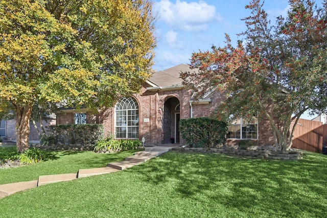 view of property hidden behind natural elements with a front lawn