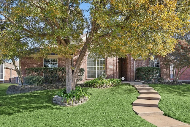 obstructed view of property with a front lawn