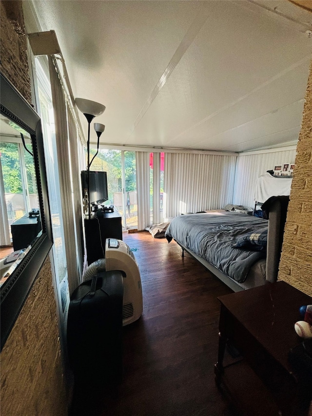 bedroom with dark wood-type flooring and vaulted ceiling