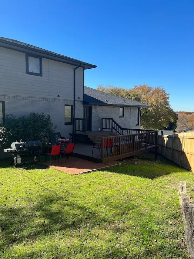 back of house featuring a yard, a deck, and a patio area