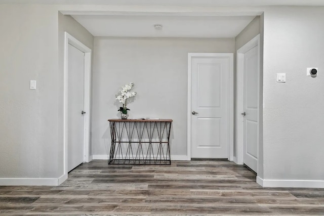 corridor with hardwood / wood-style flooring