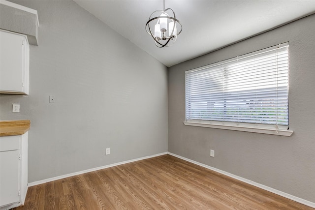 2240 Tarpley Rd Unit 462, Carrollton, TX 75006 - unfurnished dining area featuring a chandelier, light wood finished floors, and vaulted ceiling