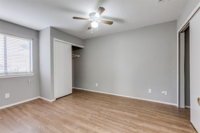 unfurnished bedroom featuring ceiling fan, a closet, and light hardwood / wood-style floors