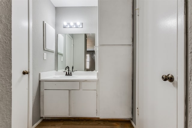 bathroom with vanity and wood-type flooring