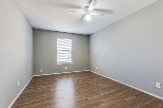 empty room with ceiling fan and dark wood-type flooring