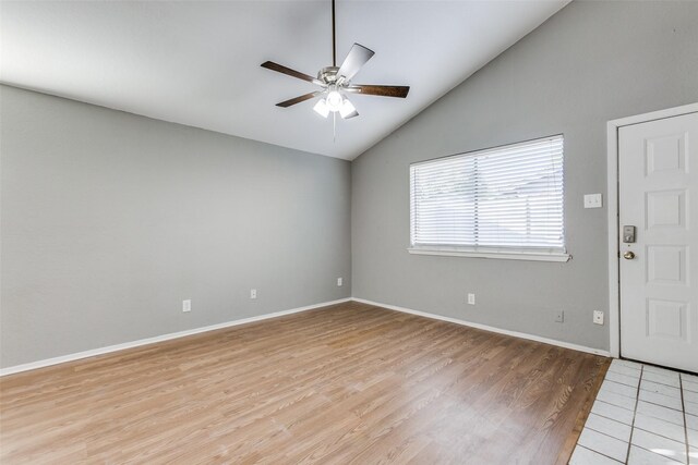 unfurnished room with ceiling fan, high vaulted ceiling, and light wood-type flooring