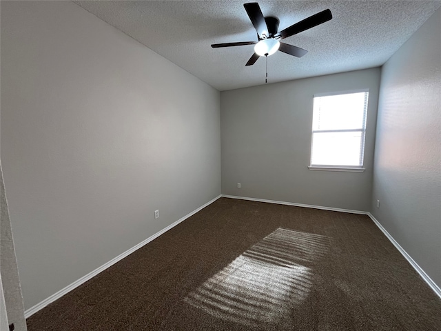 carpeted spare room with a textured ceiling and ceiling fan