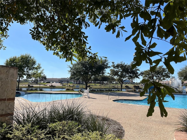 view of swimming pool featuring a patio area