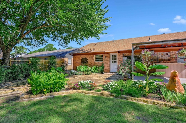 view of front of property with a patio and a front yard