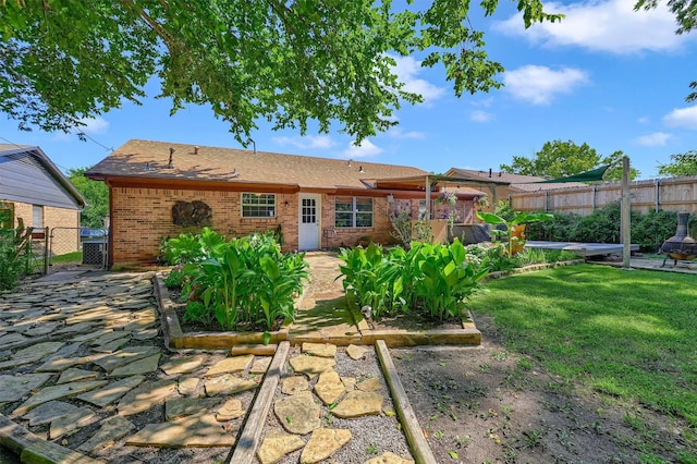 back of house with a lawn