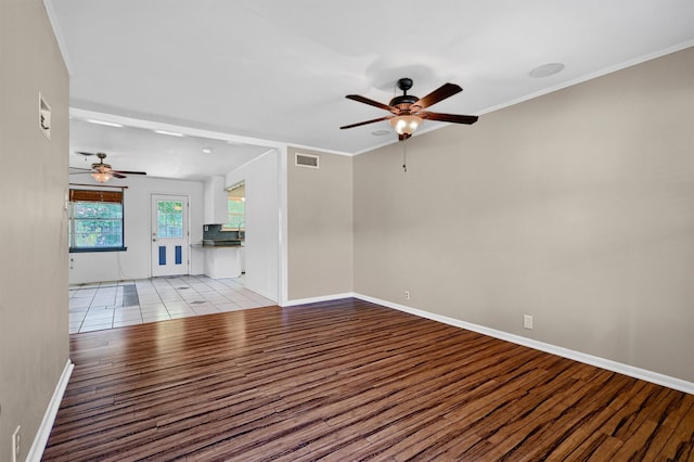 unfurnished living room featuring light wood-type flooring, ceiling fan, and crown molding