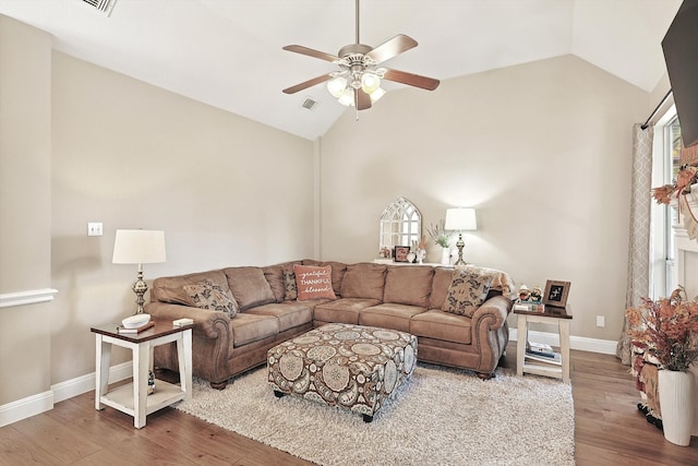 living room with ceiling fan, lofted ceiling, and hardwood / wood-style flooring