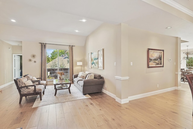 living room with light hardwood / wood-style floors and vaulted ceiling