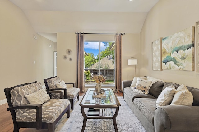 living room featuring light hardwood / wood-style floors and vaulted ceiling