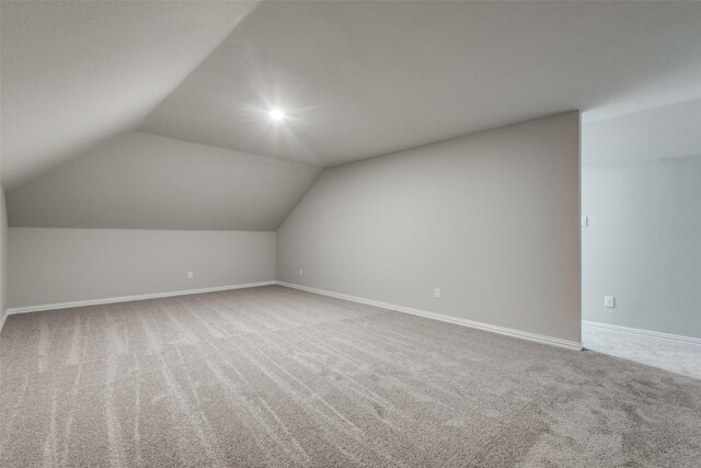 bonus room featuring carpet flooring and lofted ceiling