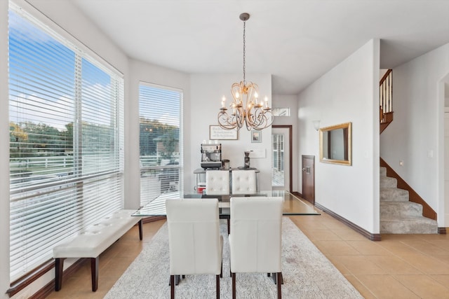 dining area with an inviting chandelier and light tile patterned flooring