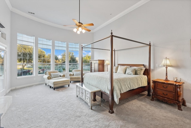 carpeted bedroom featuring ceiling fan, a towering ceiling, and crown molding