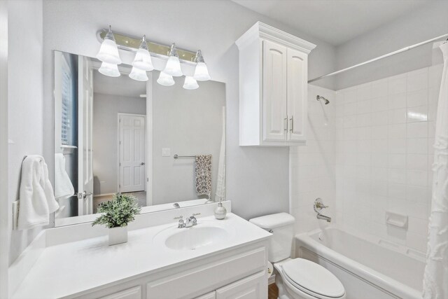 full bathroom with vanity, shower / bath combo, and toilet