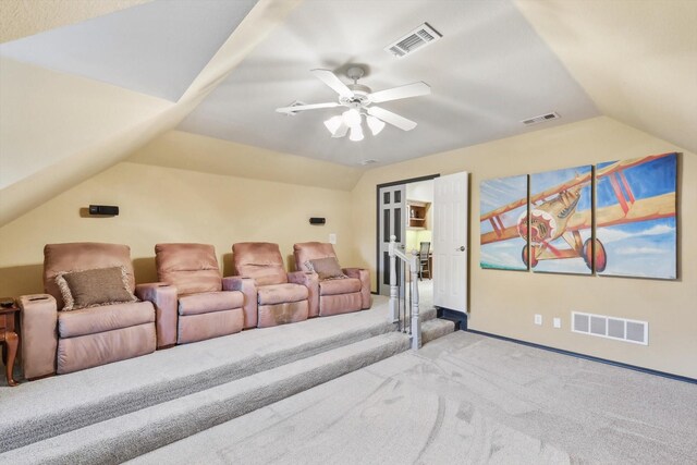 cinema room with light colored carpet, vaulted ceiling, and ceiling fan