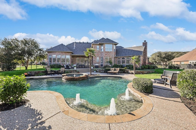 view of swimming pool featuring a lawn, an in ground hot tub, and a patio