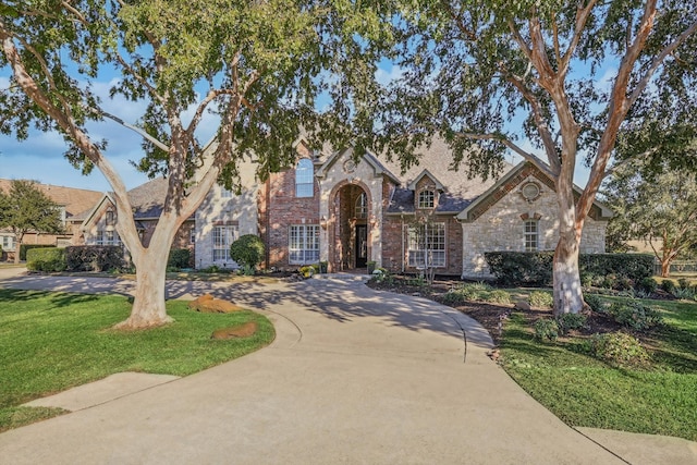 tudor home featuring a front yard