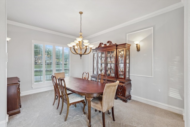 dining area featuring a chandelier, crown molding, and light colored carpet