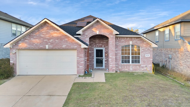 view of front property featuring a front yard and a garage