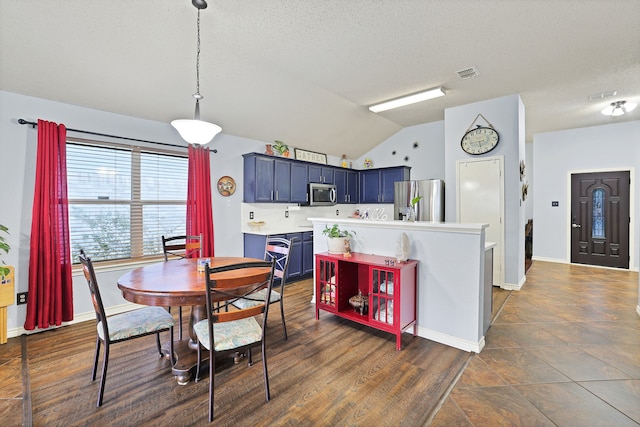 dining room featuring a textured ceiling, dark hardwood / wood-style floors, and vaulted ceiling