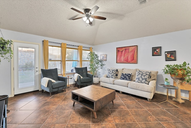 living room featuring a textured ceiling, ceiling fan, and lofted ceiling