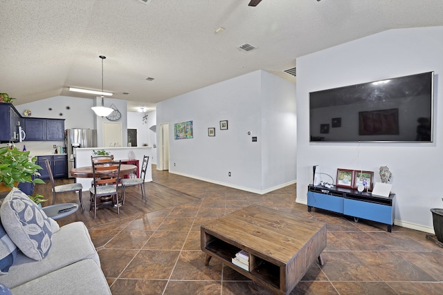 living room featuring ceiling fan, lofted ceiling, and a textured ceiling