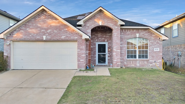 view of front of house featuring a garage and a front lawn