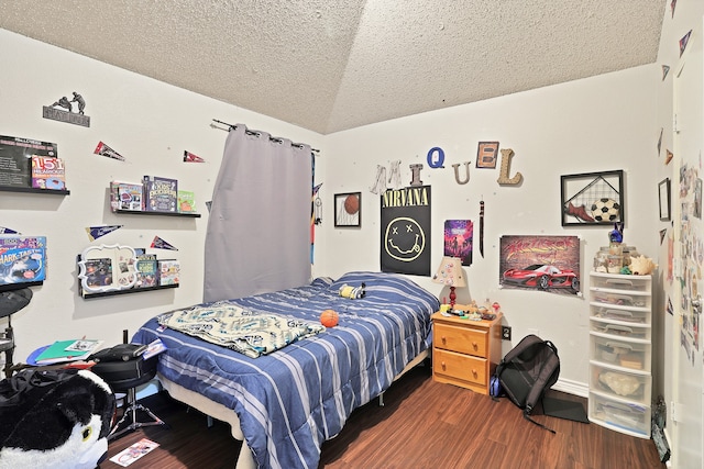 bedroom featuring a textured ceiling, dark hardwood / wood-style flooring, and vaulted ceiling