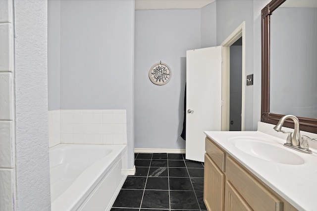 bathroom featuring tile patterned flooring, vanity, and a washtub