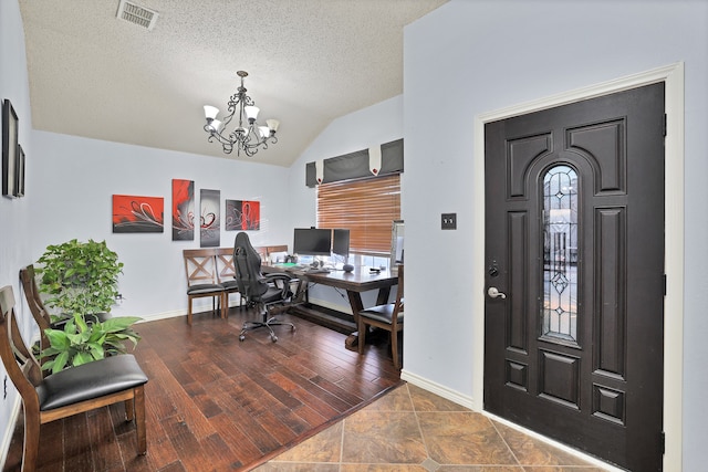 office area with a chandelier, a textured ceiling, dark hardwood / wood-style floors, and vaulted ceiling