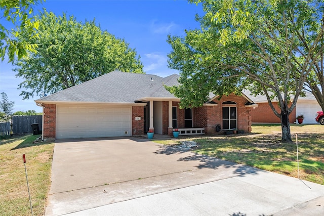 single story home featuring a front yard and a garage