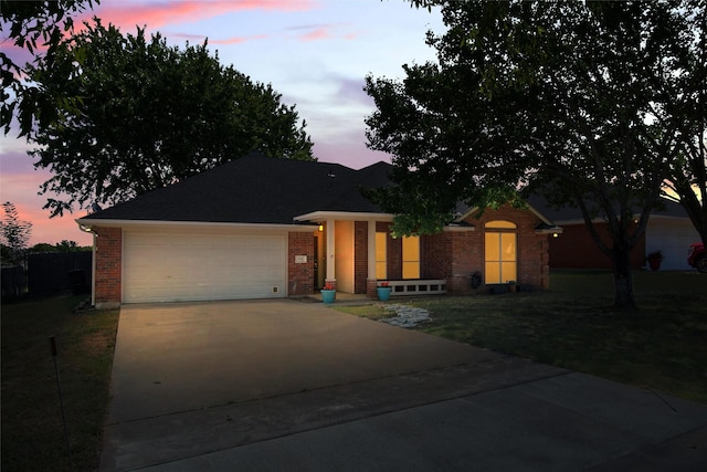 view of front of house featuring a garage and a yard