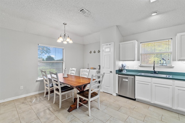 kitchen with white cabinetry, plenty of natural light, stainless steel dishwasher, and sink